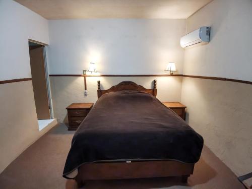 Ένα ή περισσότερα κρεβάτια σε δωμάτιο στο Hotel El Nogalito