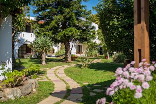a garden with a path leading to a house at Gaia Garden in Kos Town