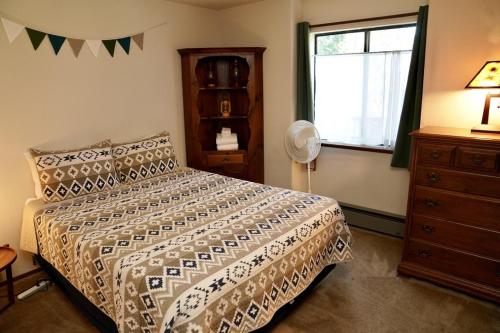 a bedroom with a bed and a window and a dresser at Forest Glen in Yosemite West