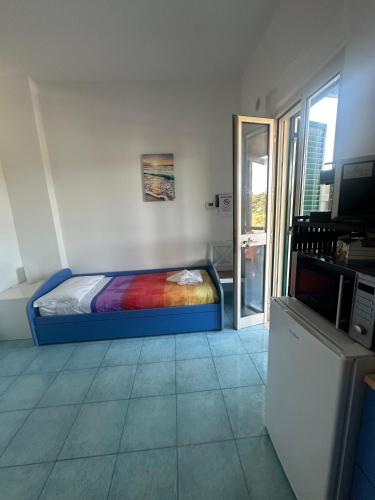 a bedroom with a bed with a colorful blanket at La Nassa Rooms in San Domino