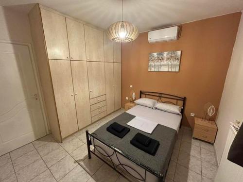 a bedroom with a bed and a table in it at Mano's house 15 minutes from the airport in Artemida