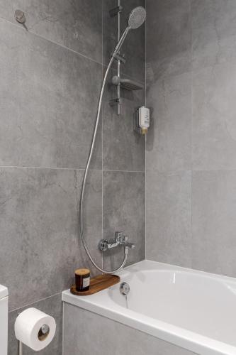 a bathroom with a shower with a bath tub at Prime Rest Apartments in Lviv