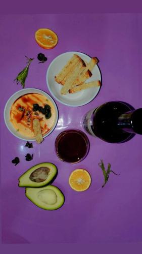 a purple table topped with plates of food and fruit at Guesthouse Mtkvari in Nak'alak'evi