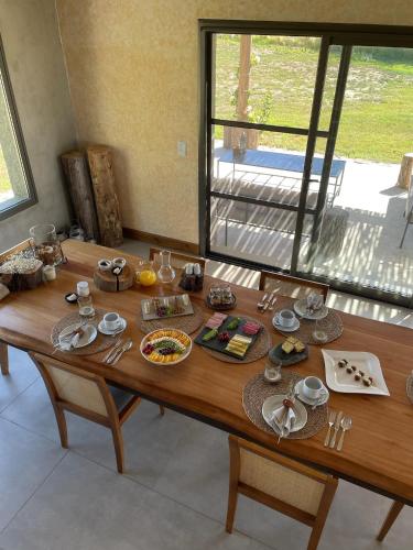 a wooden table with plates of food on it at Vivacs del Plata in Tupungato