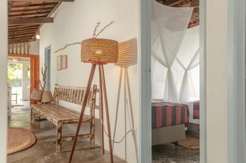 a room with a floor lamp and a bedroom at Barrinha dos Ventos Barrinha de Baixo Ceara Quartos Casas Kitesurf in Acaraú