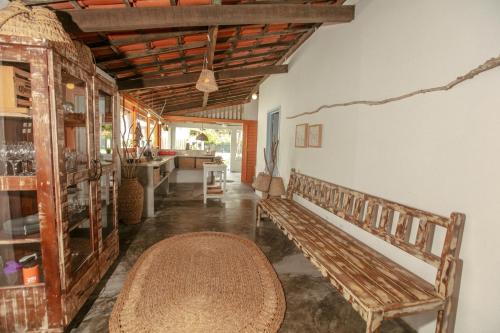 a room with a wooden bench and a table at Barrinha dos Ventos Barrinha de Baixo Ceara Quartos Casas Kitesurf in Acaraú