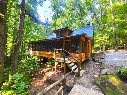 a wooden house in the middle of a forest at Ma & Pa's cabin at Cabin Fever in NC in Saluda