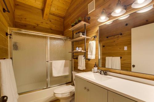 a bathroom with a shower and a toilet and a sink at Covered Deck, Private Acreage: Log Cabin in Pine in Pine