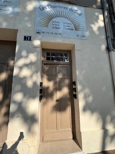 a door to a building with a sign above it at La Topaze in Narbonne