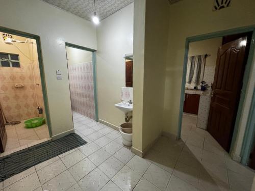 a bathroom with a toilet and a shower and a sink at Tekas Housing - Ngong Hills in Kiserian