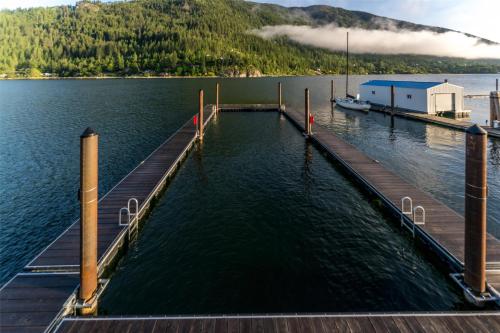 a dock on a lake with a boat in the water at Prestige Lakeside Resort, WorldHotels Elite in Nelson