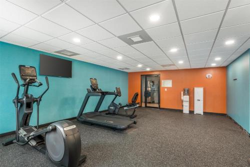 a gym with three tread machines in a room at Best Western Manchester in Manchester