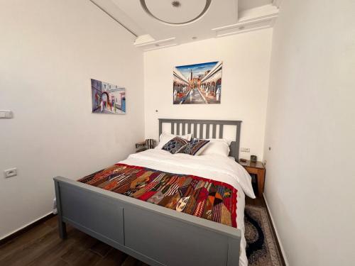 a bedroom with a bed in a room at Nour roof top apartment in Essaouira