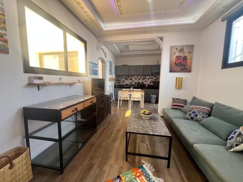a living room with a couch and a table at Nour roof top apartment in Essaouira