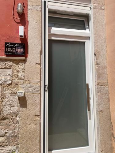 a window on the side of a brick building at Mariaaltomare in Andria