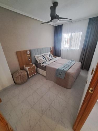 a bedroom with a bed and a ceiling fan at Paradiso de Playa LaMata in La Mata