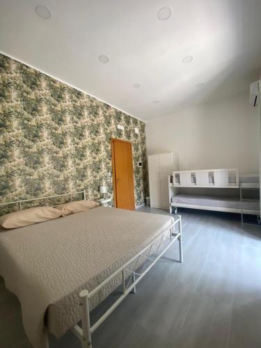 a bedroom with a bed and a wall at Casa Vacanze Gioia in Pellezzano