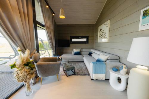 a living room with a couch and a table at SEOVILLAGE Resort & Spa in Ķeipene