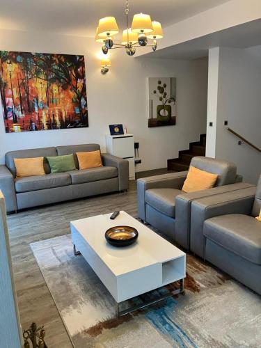 a living room with couches and a coffee table at Silver Luxury 6 in Poiana Brasov