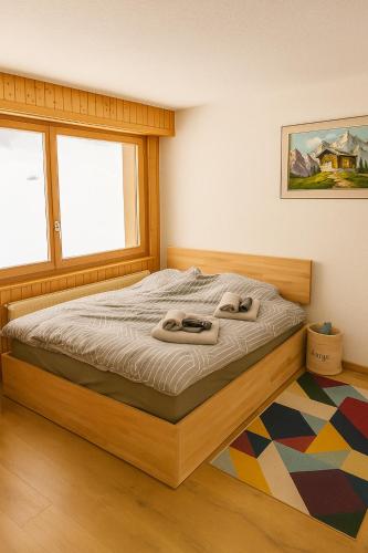 a bedroom with a bed with two towels on it at Petit havre de paix! in Les Collons