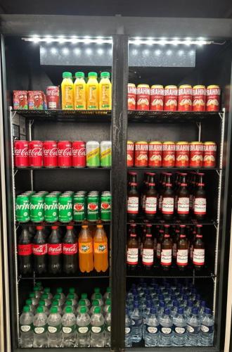 a refrigerator filled with lots of drinks and soda at Novo Hotel Uirapuru in Araraquara