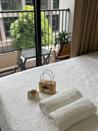 a bed with two boxes on top of it at Hayden Home Ocean Park 3 in Ðình Loan