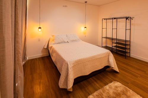 a bedroom with a bed in a room at Recanto Alto dos Cuiabás in Tiradentes