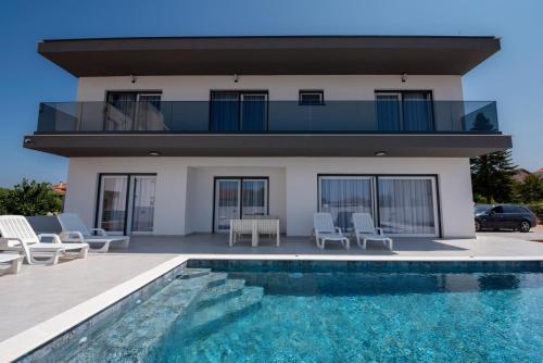 a villa with a swimming pool and a house at Villa Vibiana Lux Bibinje in Bibinje