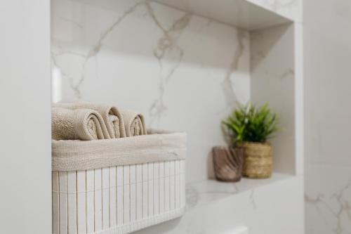 a white bathroom with towels and a mirror at Njivice Coastal Oasis in Njivice