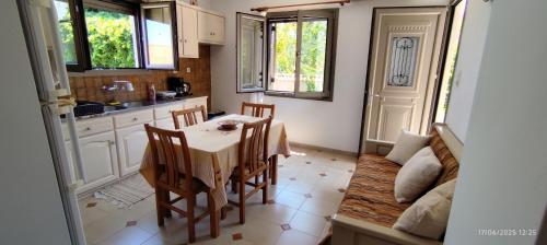 a kitchen and dining room with a table and chairs at Traditional village house in Kleió