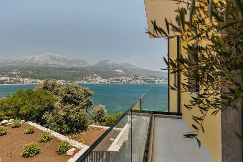 a balcony of a building with a view of the water at Njivice Coastal Oasis in Njivice