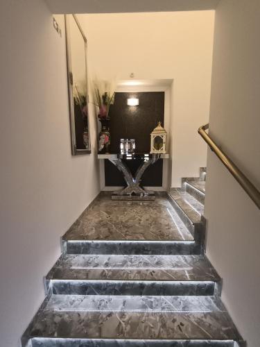 a set of stairs with a table on top at Apartmani Jozić in Garešnica