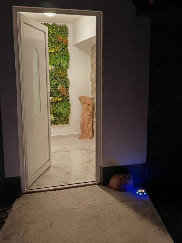 a person laying on the floor in front of an open door at Apartmani Jozić in Garešnica