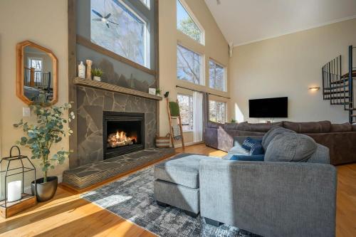 a living room with a couch and a fireplace at Lakeshore Retreat with Lake Lanier views & hot tub in Landrum