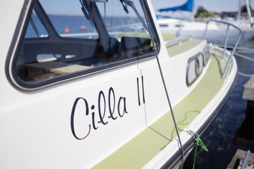 a white boat with the word clio on the side at Laiva Engures ostā in Engure