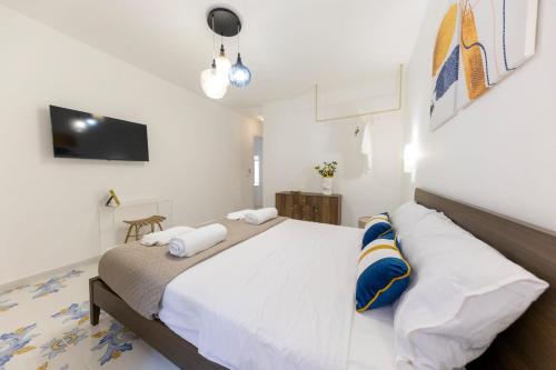 a bedroom with a large bed with two pillows at Casa Zio Lele in Cefalù