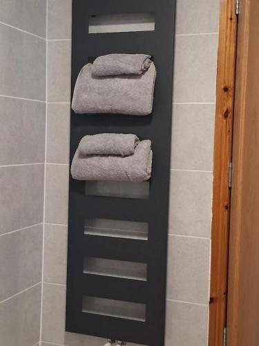 a black towel rack in a bathroom with towels at Dingle View Room in Dingle