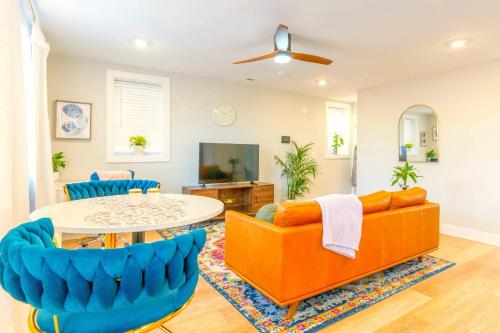 a living room with a couch and a table at Elegant Urban Escape - 2 Bedrooms, 1 king Bed and 1 Queen Bed, Gated Private Entrance and Parking in Philadelphia