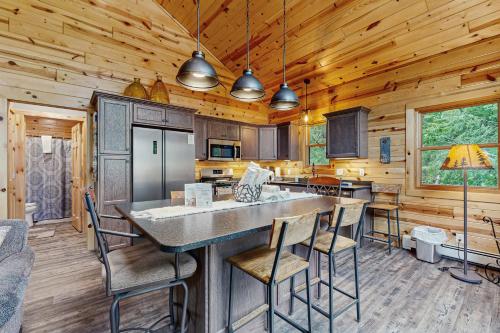 a kitchen with a large island in a log cabin at Beacon Point in Presque Isle