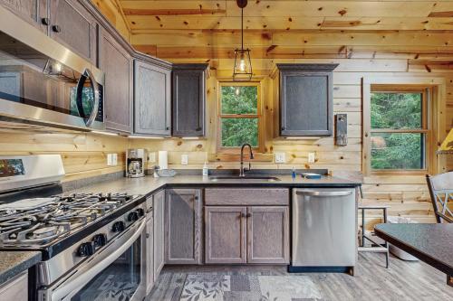 a kitchen with wooden cabinets and a stove at Beacon Point in Presque Isle