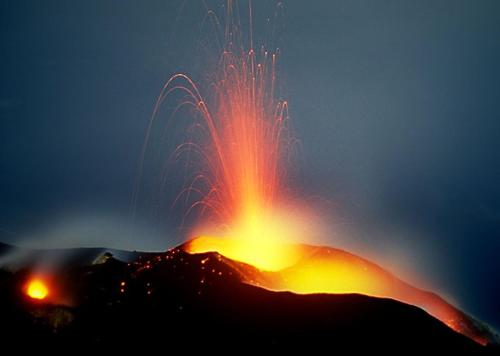 a mountain with a fire show on top of it at CasaEolia Golden in Canneto