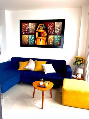 a living room with a blue couch and a table at Casa en la playa Costa y Mar 4 in San Jacinto
