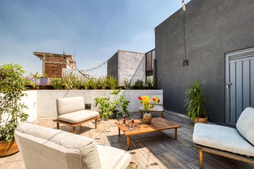 a patio with two chairs and a table on a building at MEDELLIN by Mr W in Mexico City
