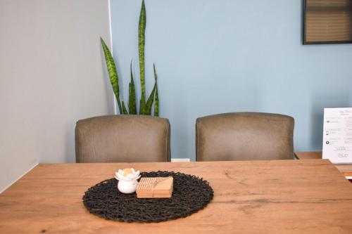 a table with two chairs and a box on a rug at Desert Nest I in Swakopmund
