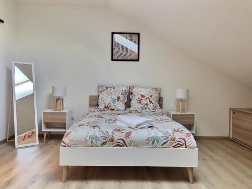a bedroom with a bed and two night stands at Appartement spacieux et lumineux proche gare in Ambérieu-en-Bugey