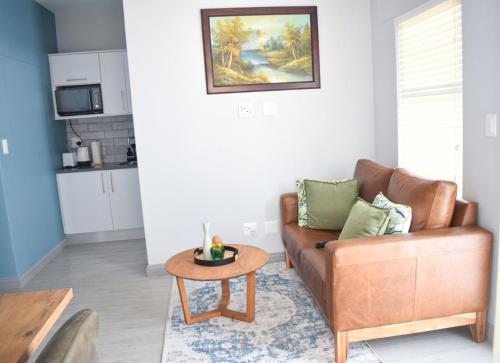 a living room with a couch and a table at Desert Nest I in Swakopmund