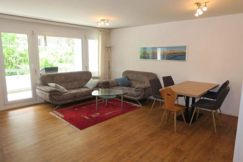 a living room with a couch and a table at Ferienwohnung in den Flumserbergen in Flumserberg