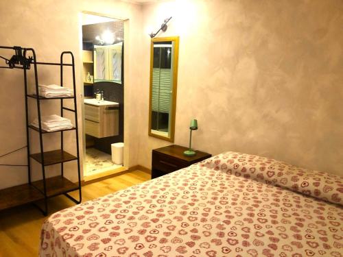 a bedroom with a bed and a bathroom with a sink at Bouganville in Arona