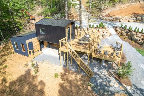 an overhead view of a tiny house with stairs at The Atlas Cedar Treehouse at Treetop Escapes in Wildwood