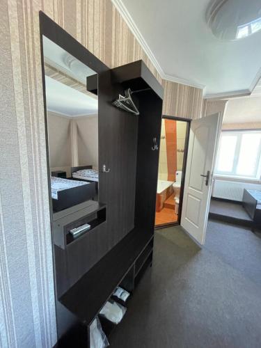 a room with a large black cabinet with a mirror at GT Hotel in Chernivtsi